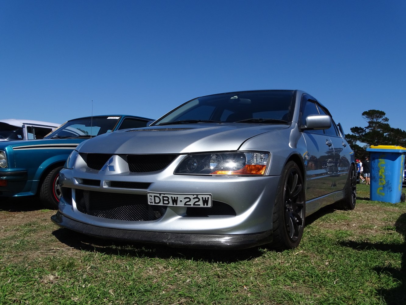 Aggressive front fascia and black alloy wheels on a sporty silver sedan.