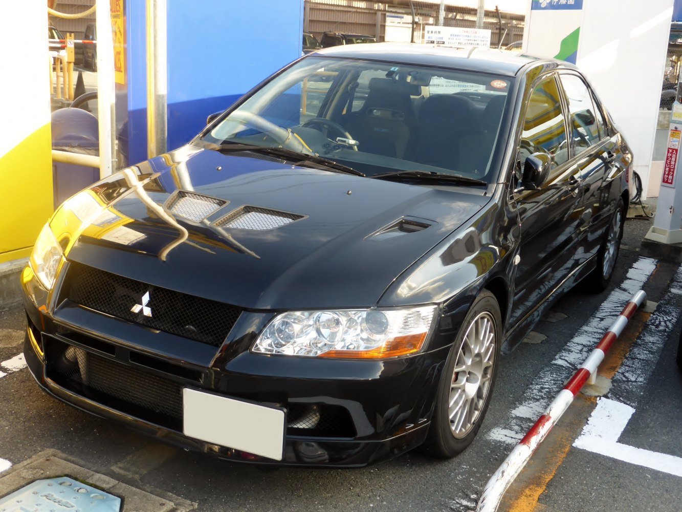 Sporty black sedan with hood vents and alloy wheels