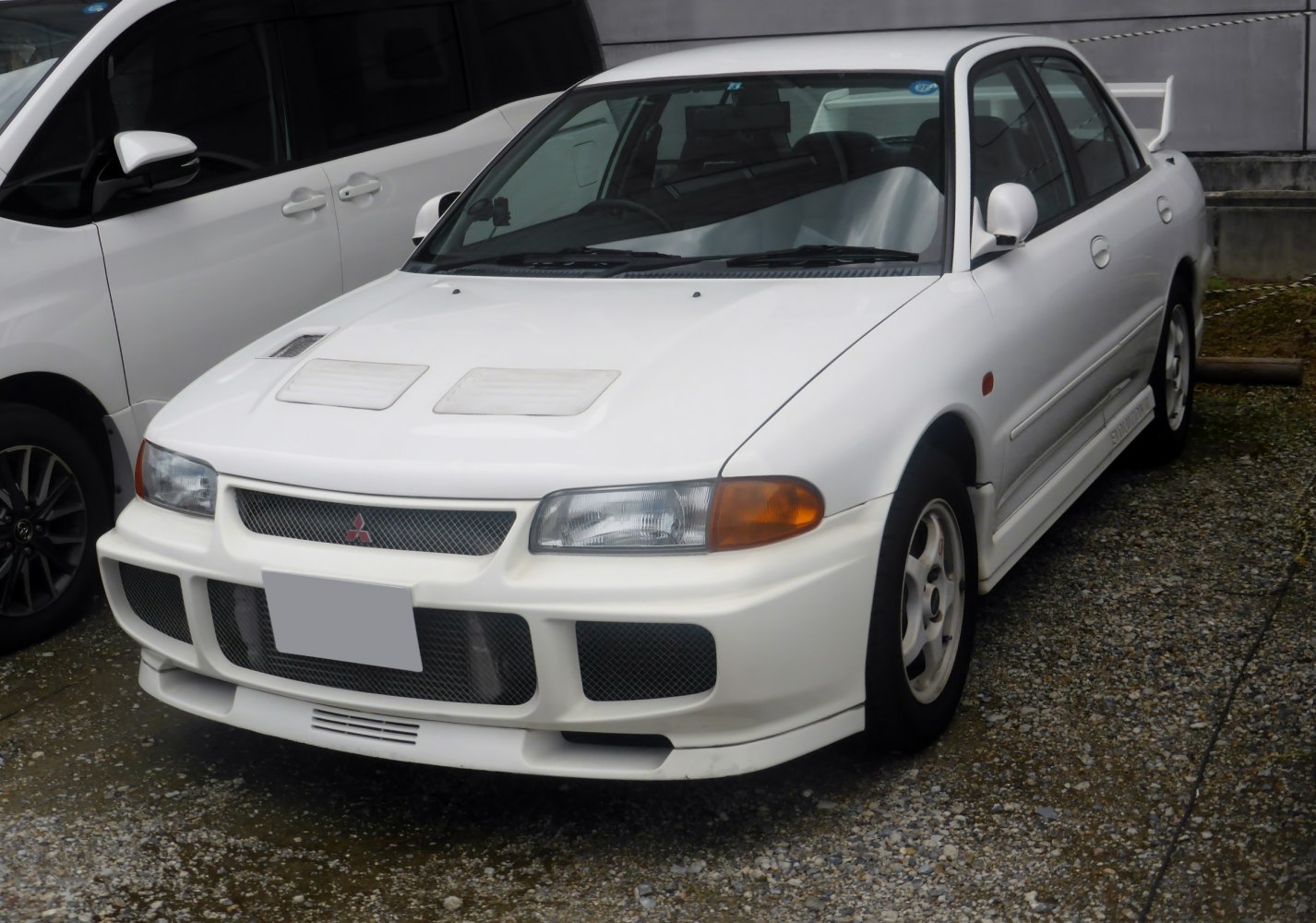 Front view with hood vents and aggressive aerodynamic body kit.