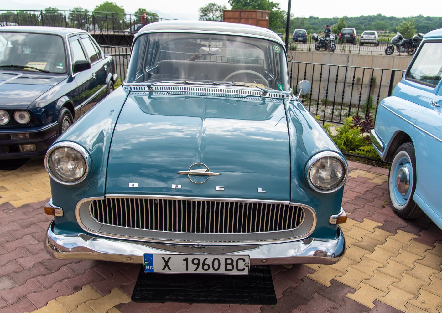 Classic car front with vertical grille and round headlights