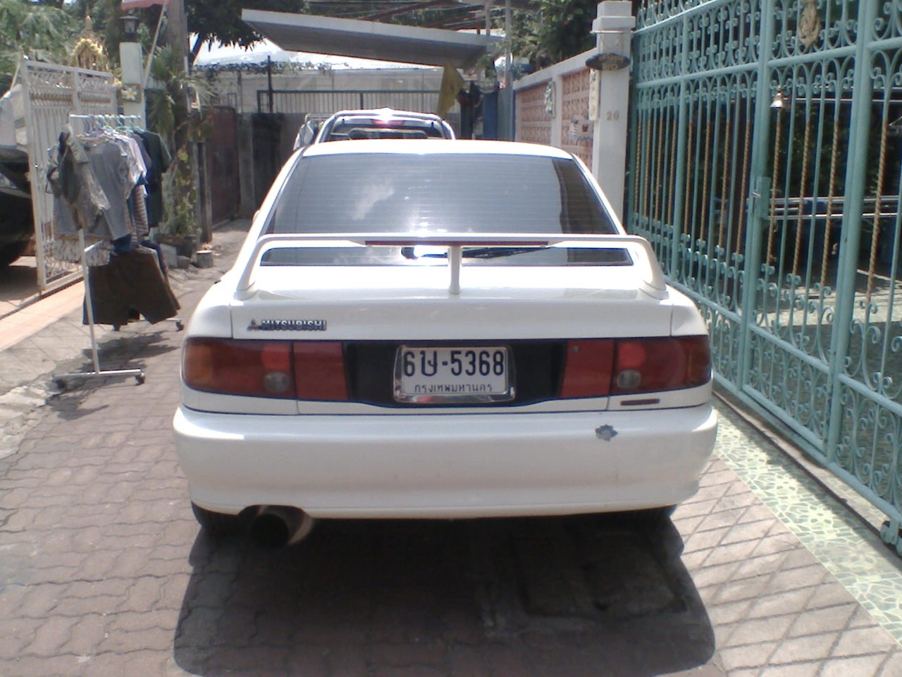 White sports coupe with rear spoiler and dual taillights