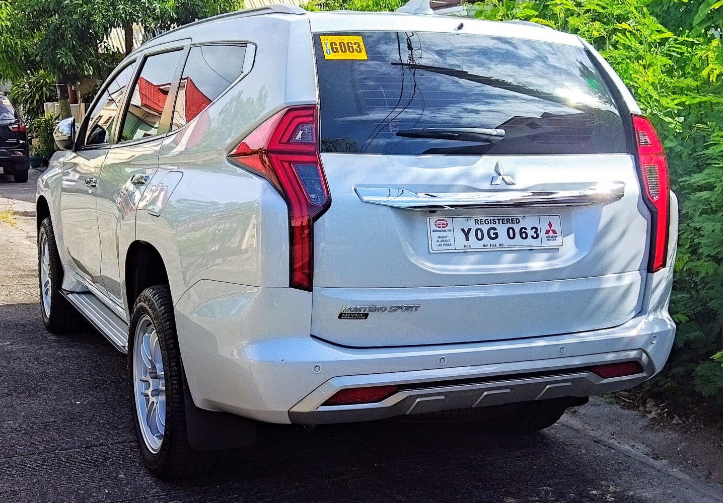 Rear view with distinctive vertical tail lights and chrome trim.