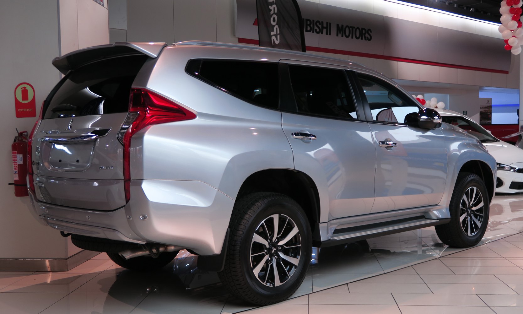 Silver SUV rear side with distinctive tail lights and alloy wheels