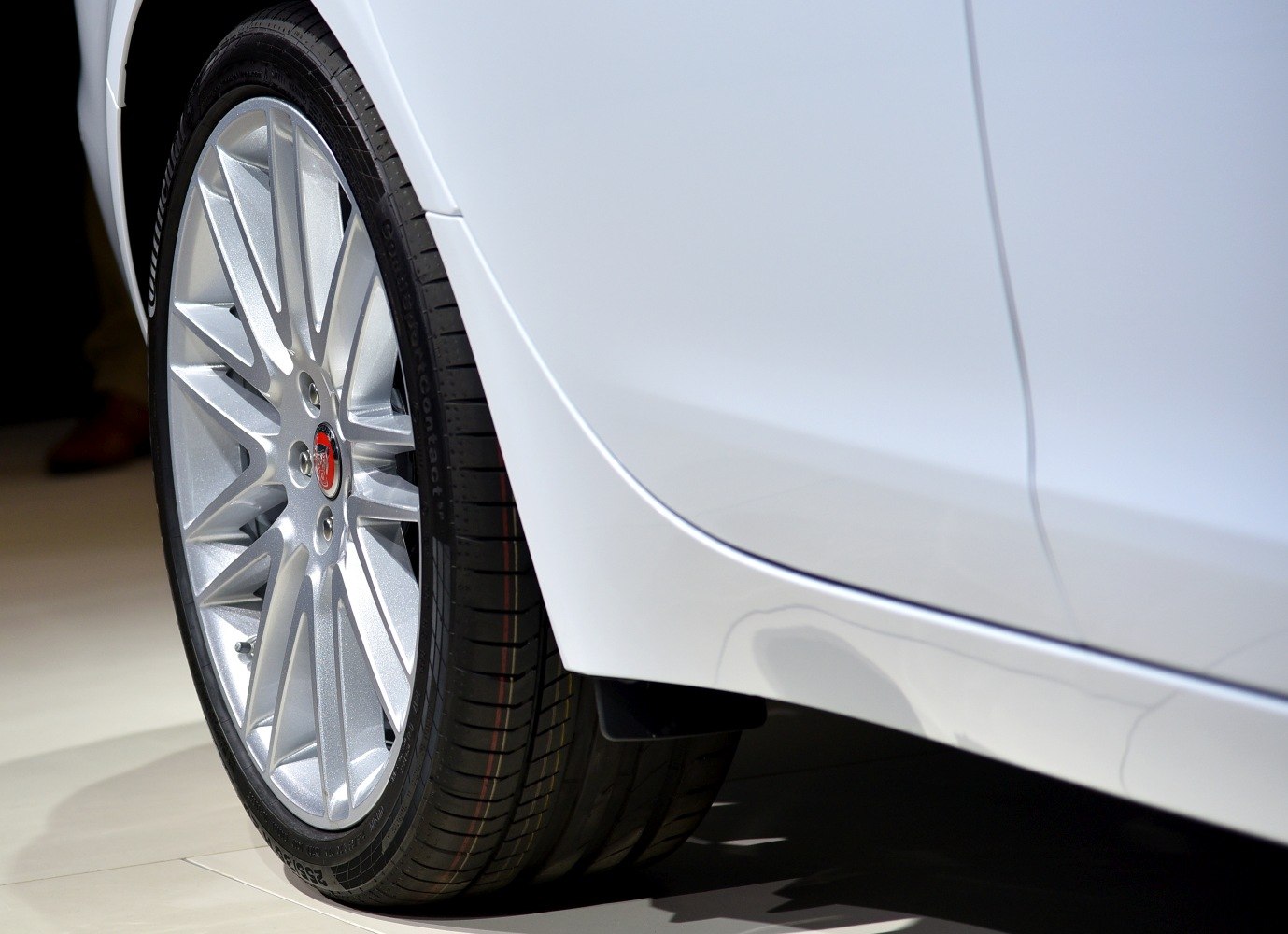 Silver alloy wheel and white car side panel