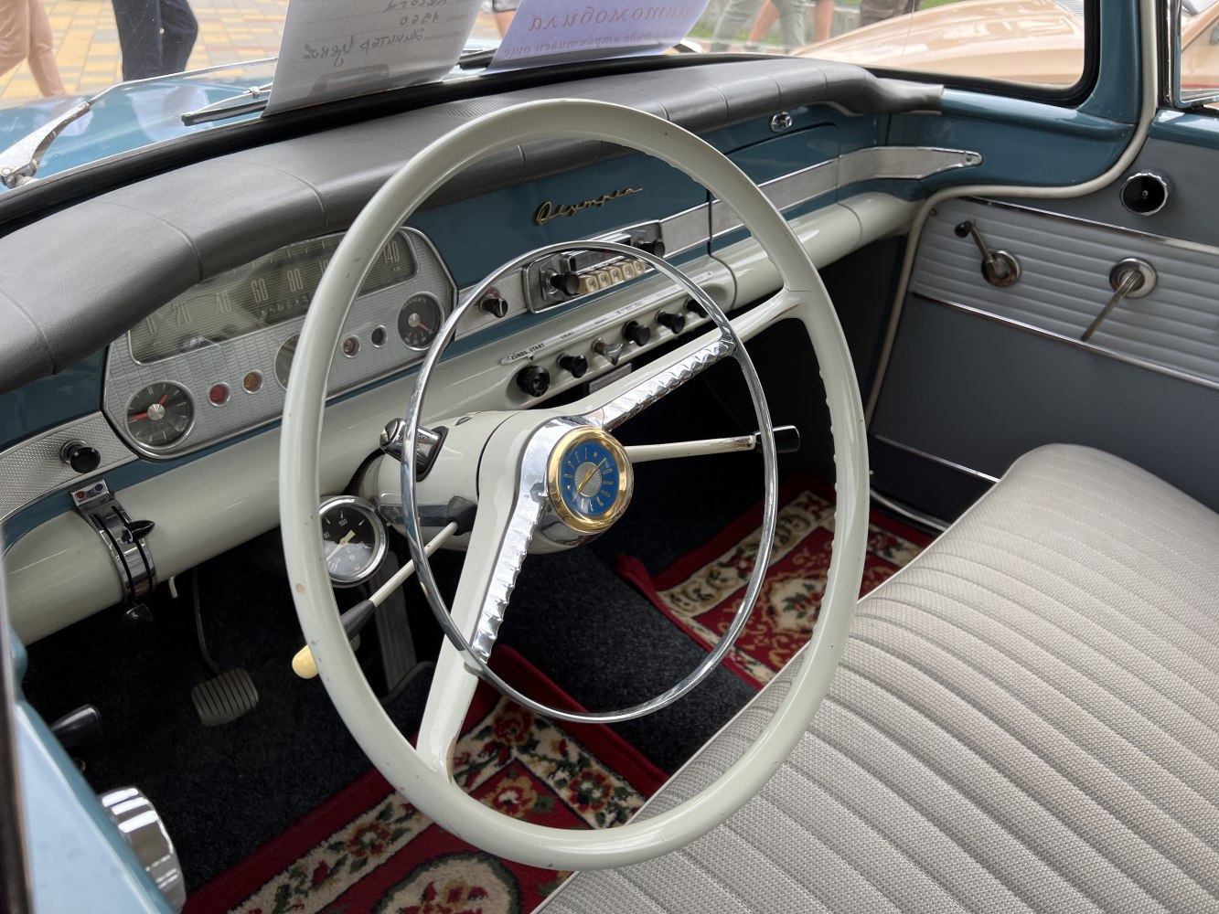 Vintage steering wheel and dashboard with analog gauges and retro controls