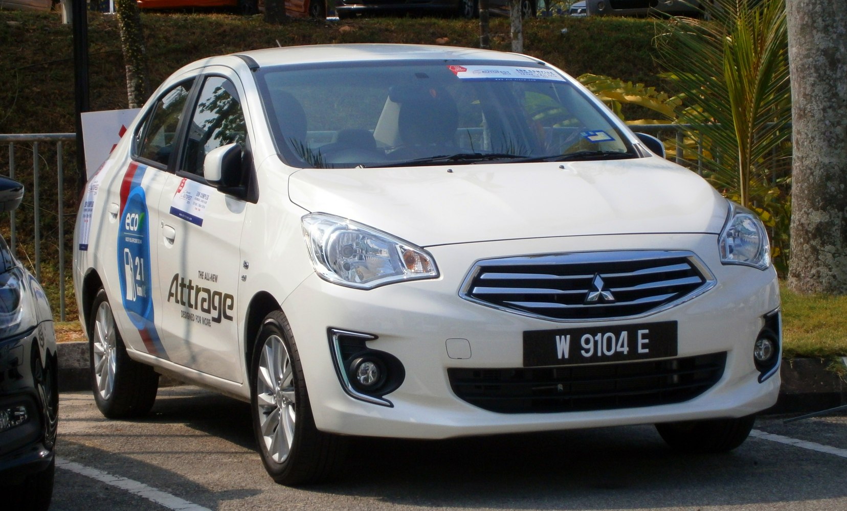 Front view of a white compact sedan with distinctive grille and headlights