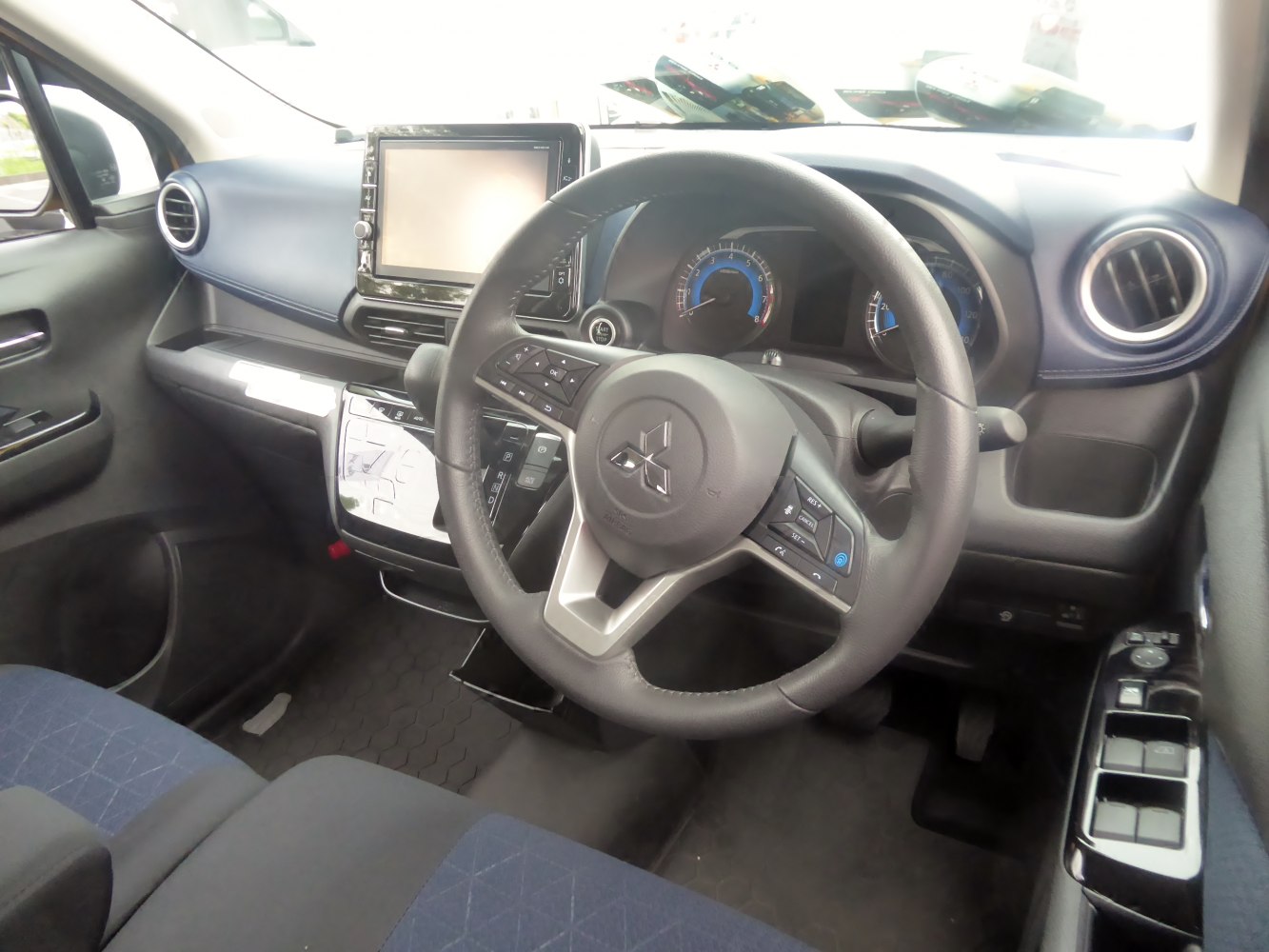 Interior showing steering wheel, touchscreen, dashboard, and air vents