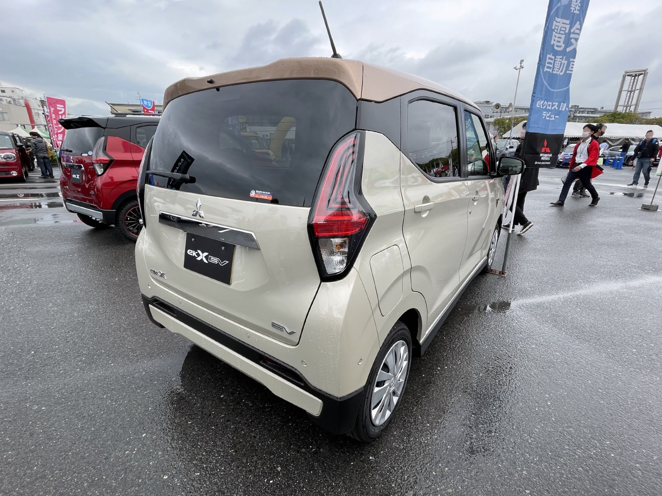 Rear view of compact vehicle with EV badge and distinct tail light design