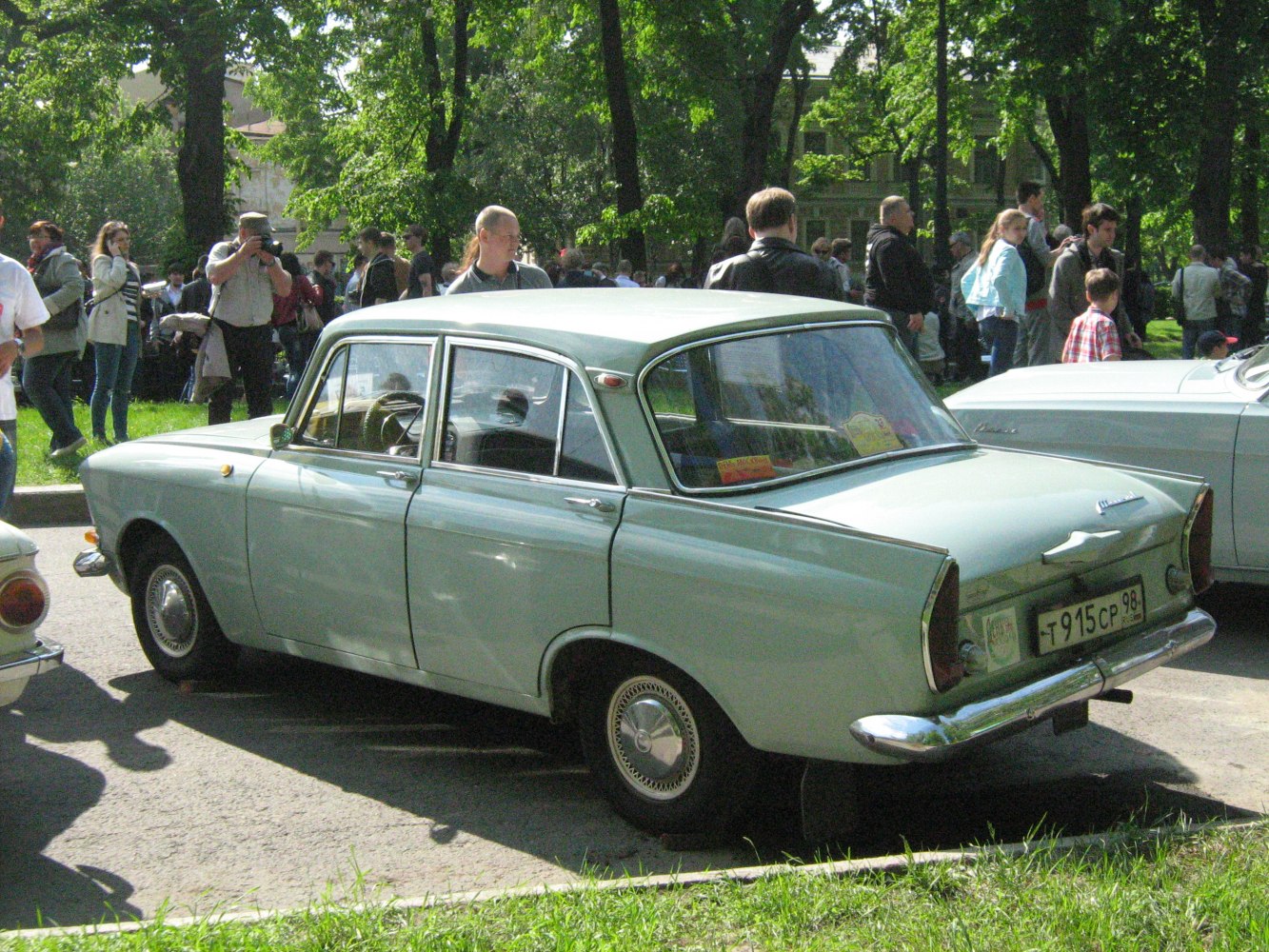 Vintage four-door sedan with tail fins and chrome bumper