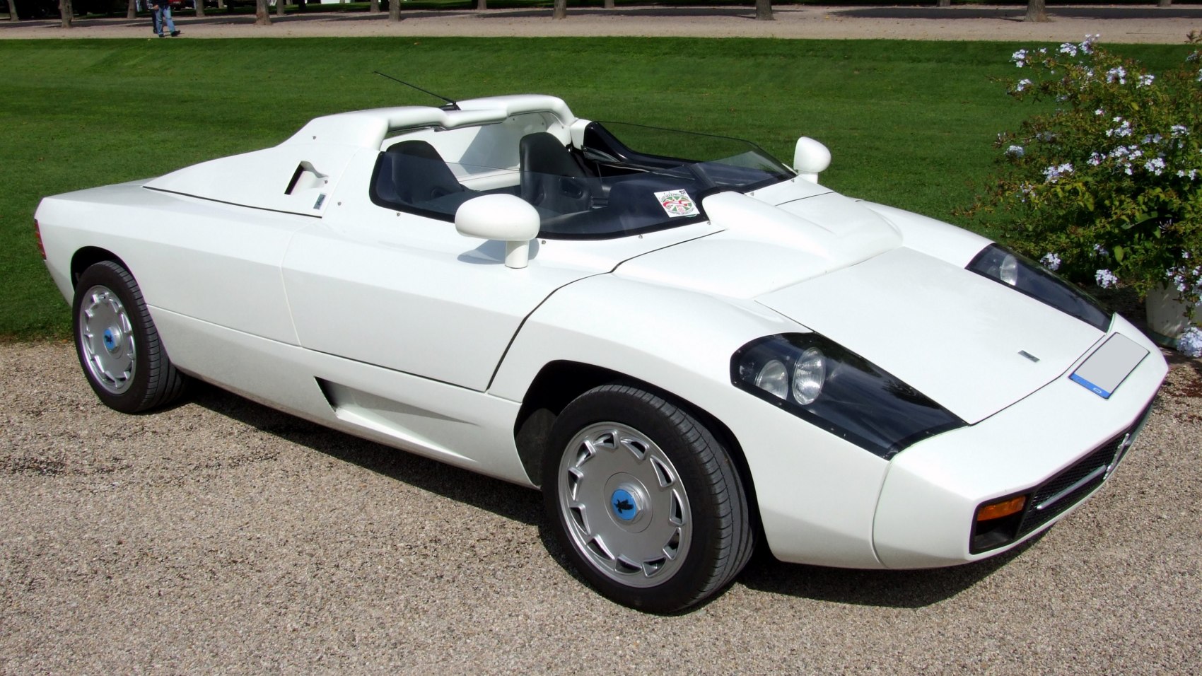 White open-top mid-engine sports vehicle with retro design