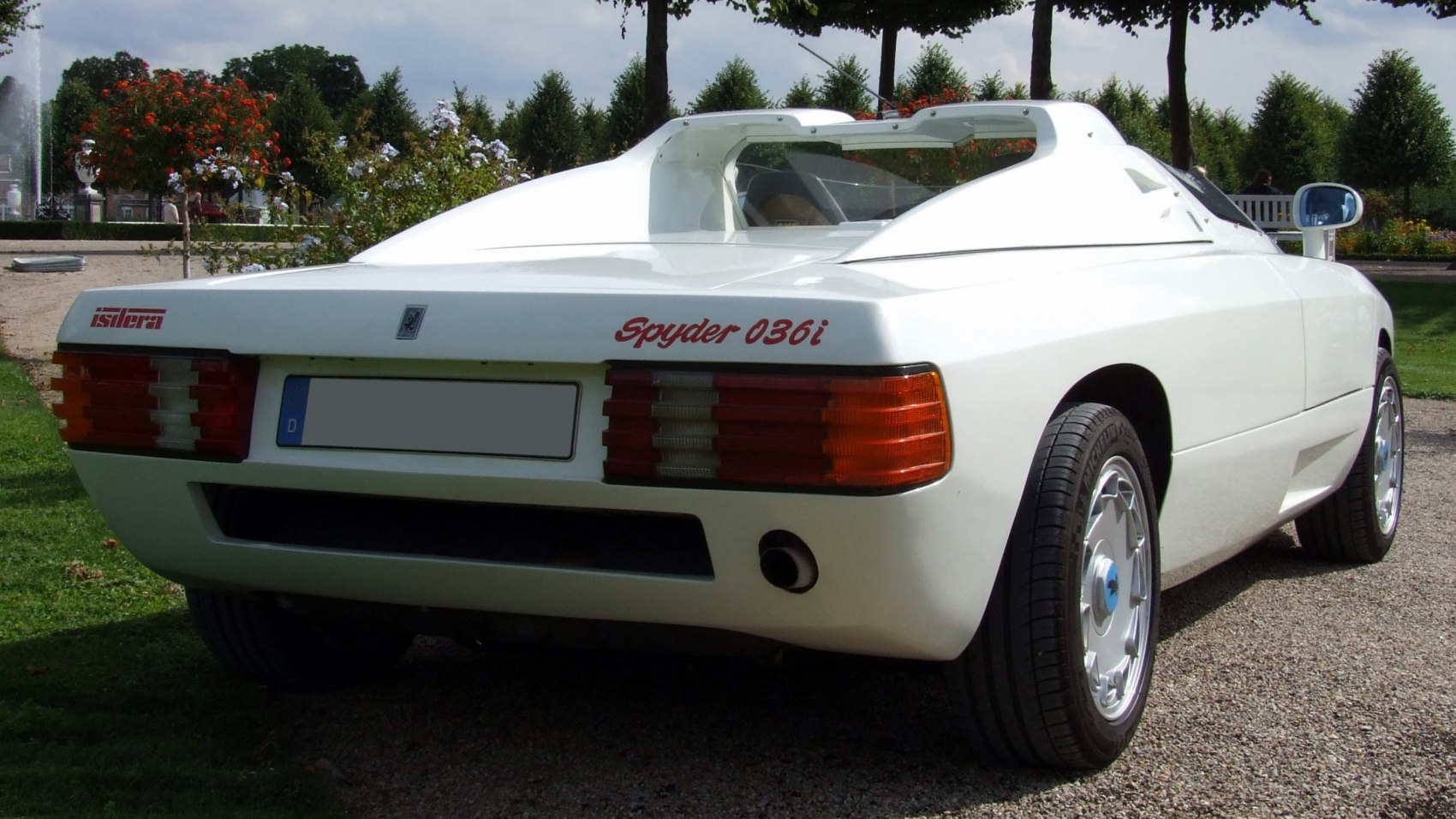 Rear view of white sports car with distinct wide taillights and open cockpit