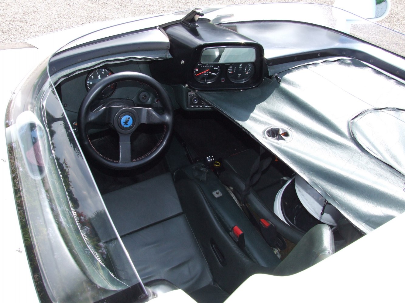 Classic dashboard and steering wheel with instrument cluster in open cockpit