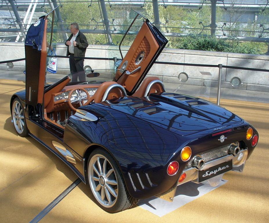 Convertible sports coupe with scissor doors and tan leather interior