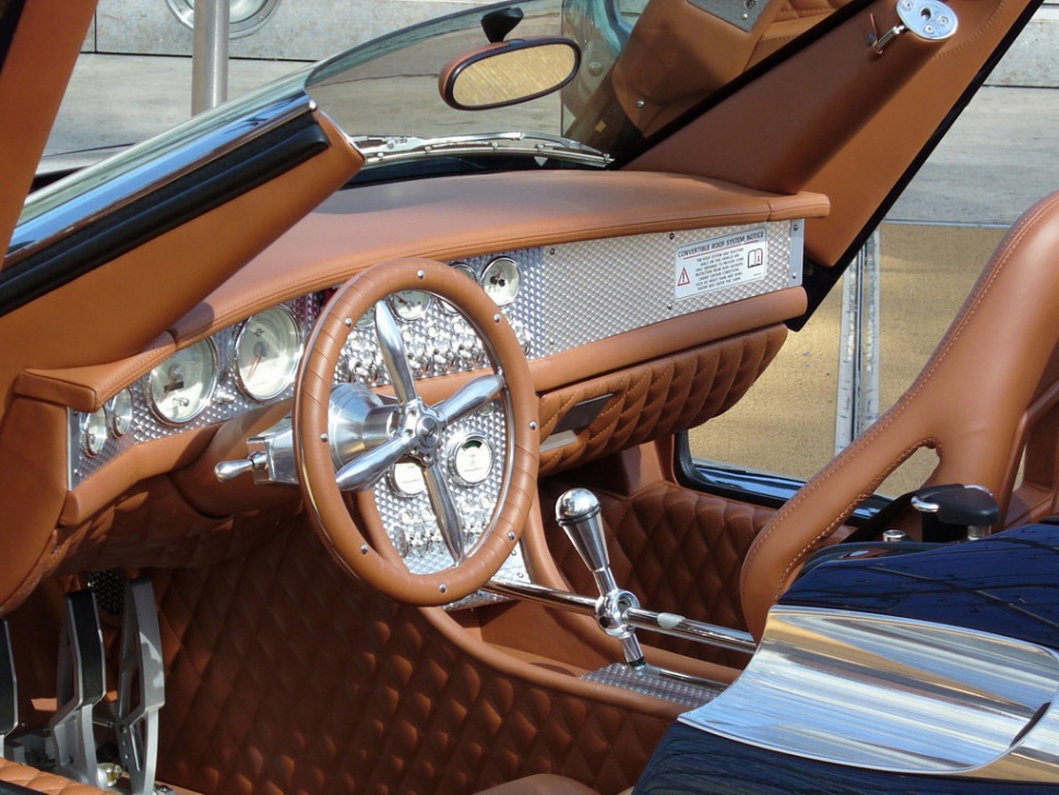 Brown leather interior with polished metal dashboard and classic steering wheel