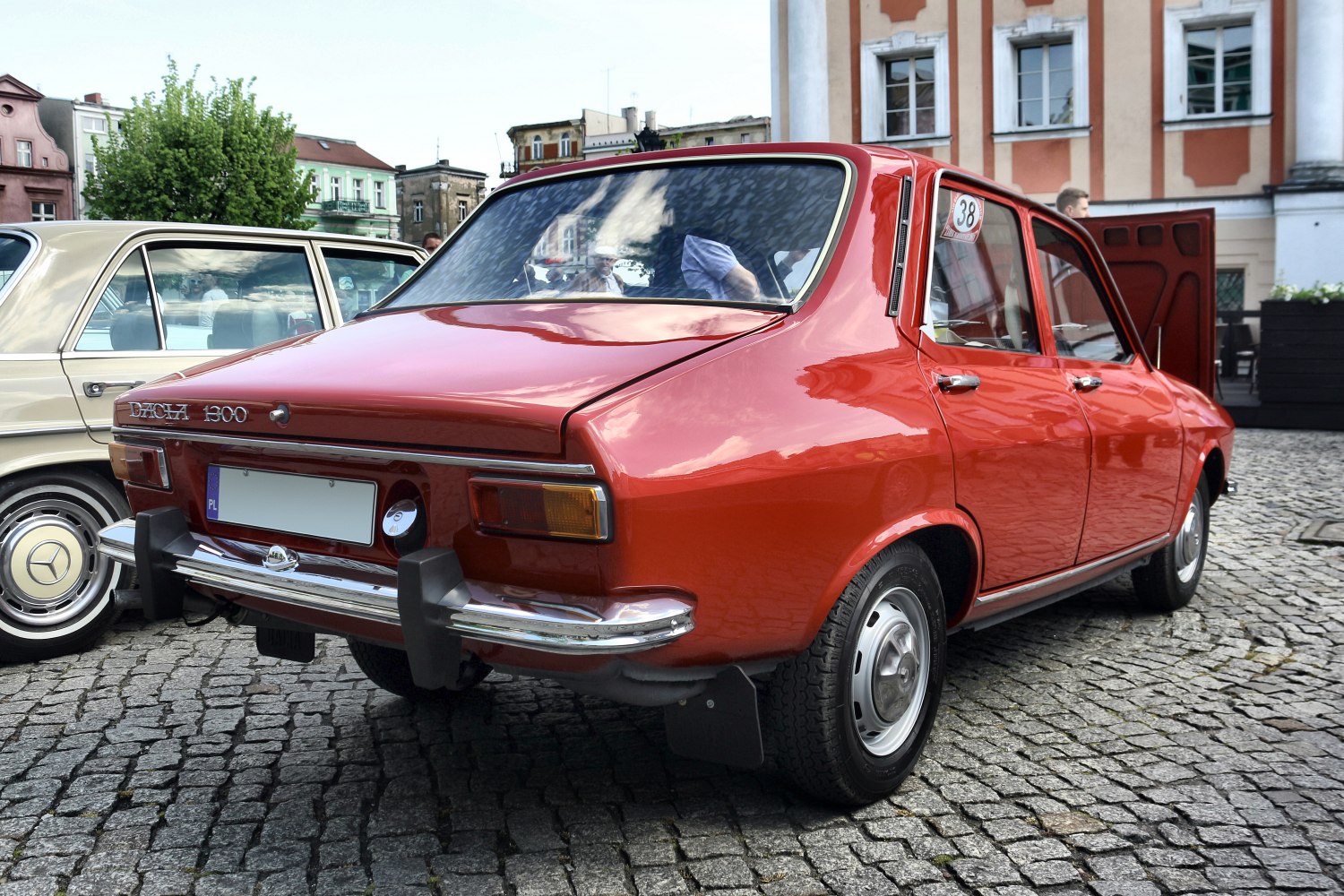 Retro rear design with chrome bumper on a red vintage sedan