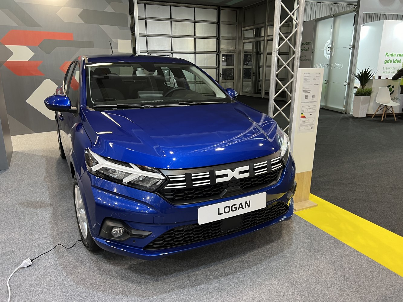 Front view of blue Logan III facelift with LED headlights and distinctive grille