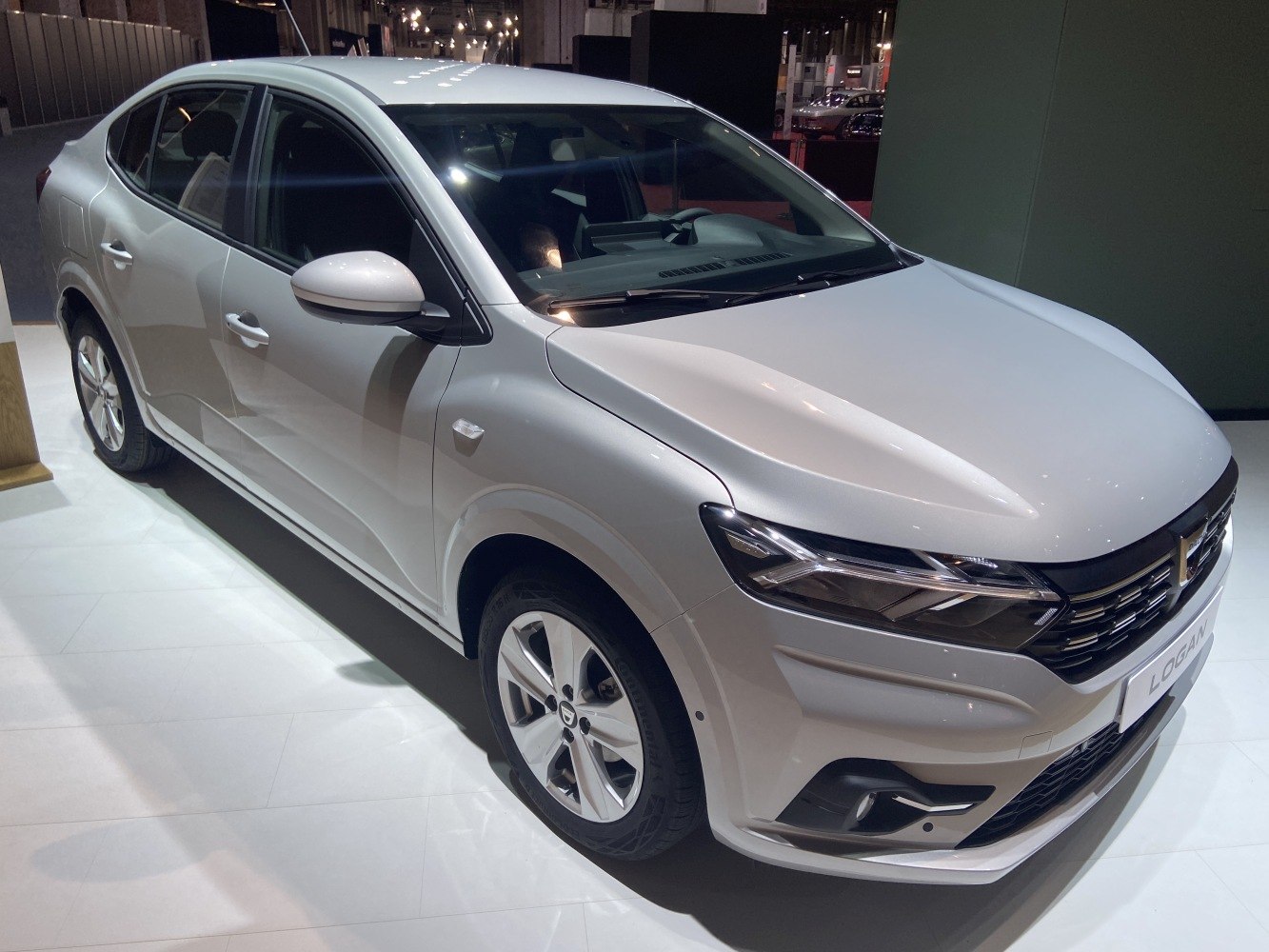 Modern sedan front view with sharp headlights and bold grille