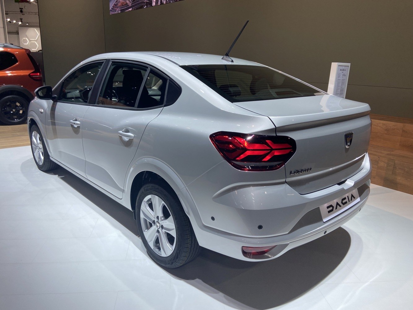 Rear side view with LED tail lights and sleek sedan body.