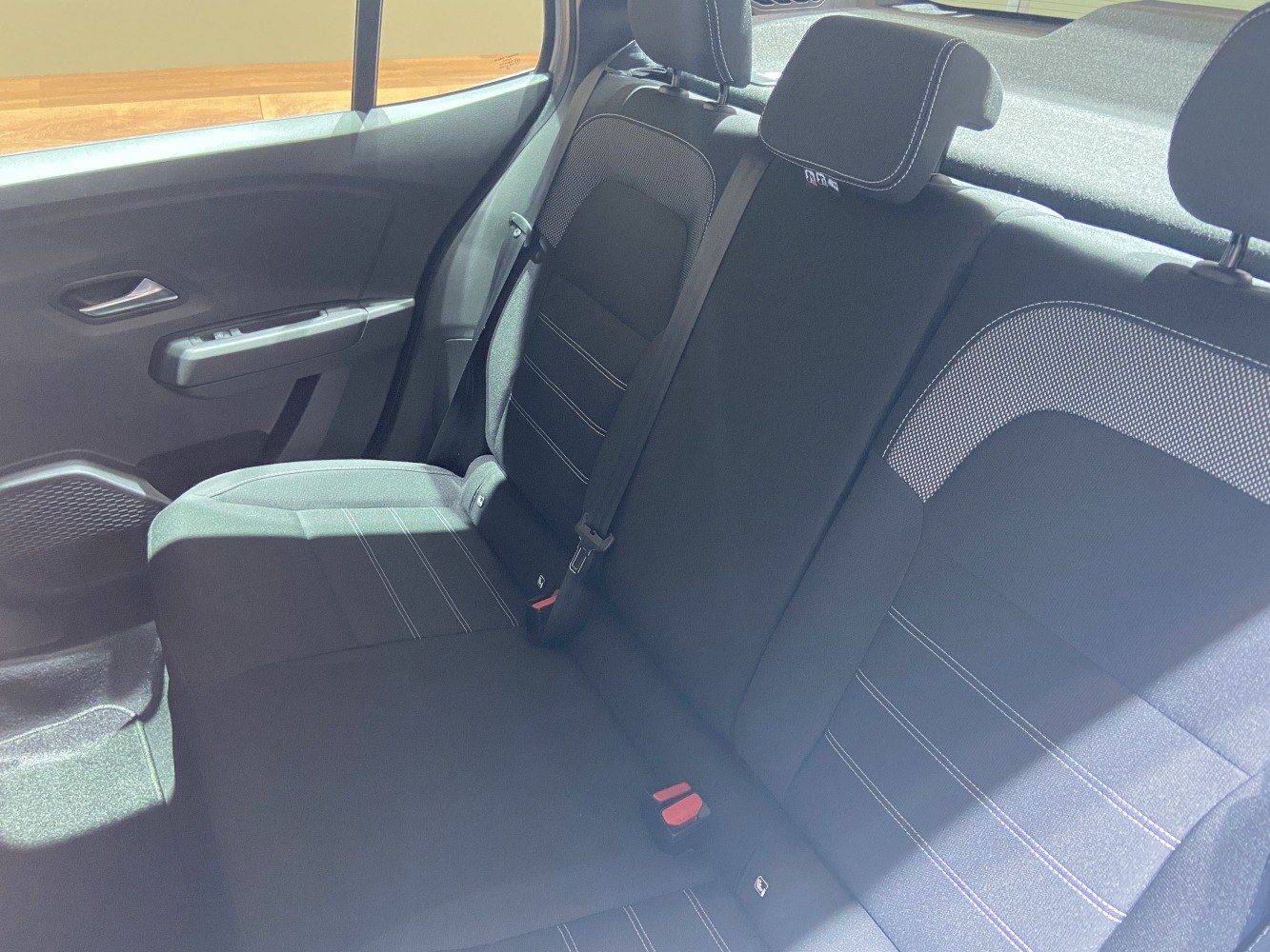 Rear seat interior with fabric upholstery and stitching details