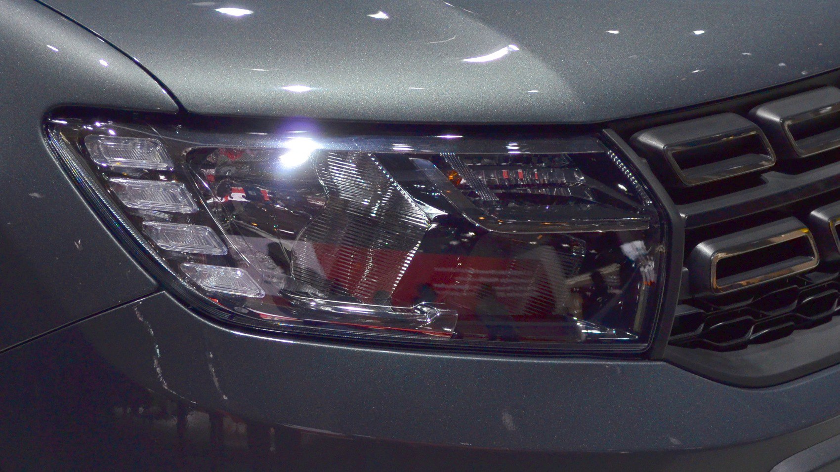 Close-up of modern front headlight and grille