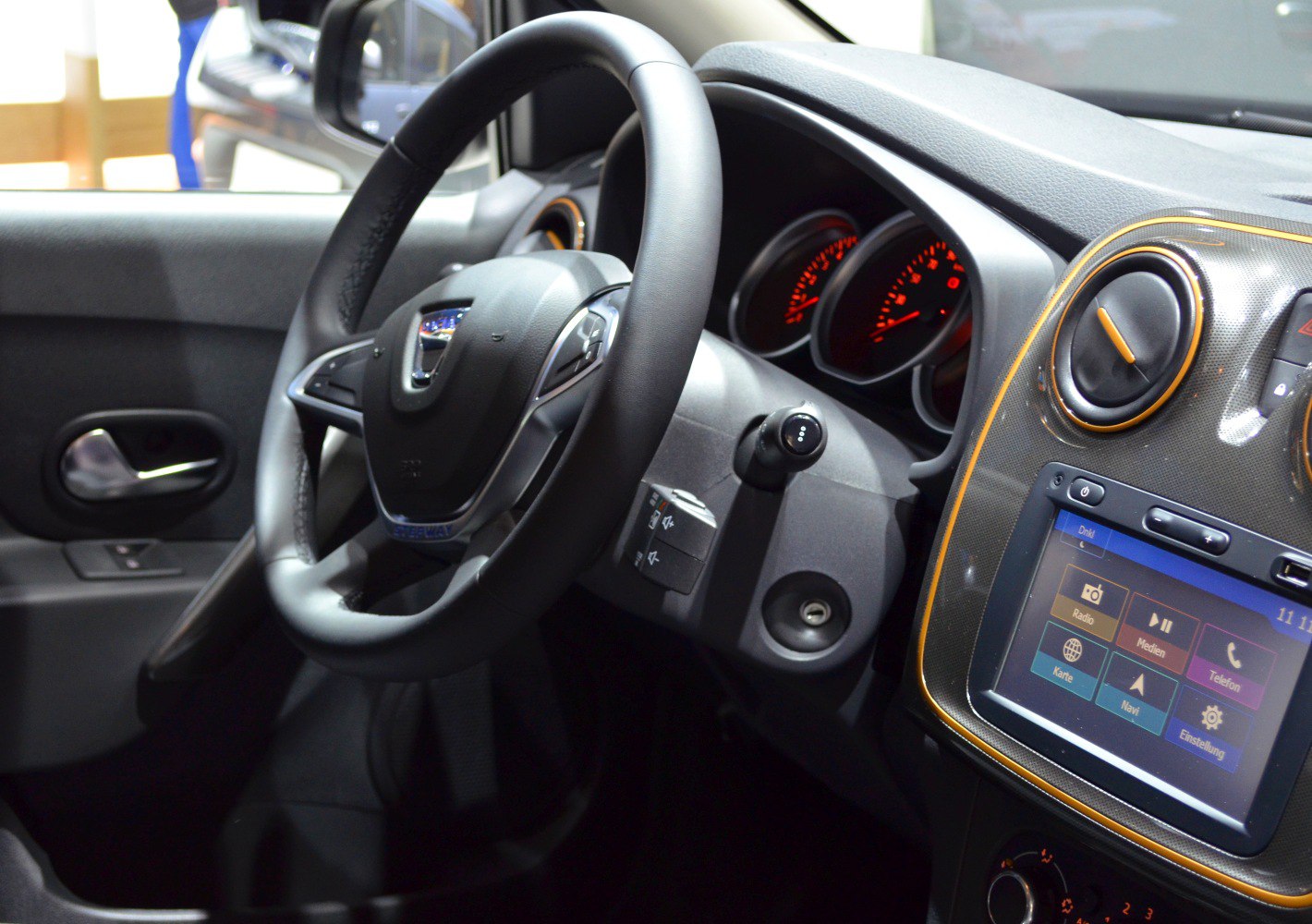 Dashboard with steering wheel, digital display, and air vents