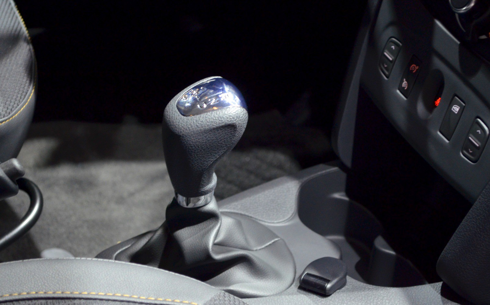 Manual gear shift lever and interior control panel close-up