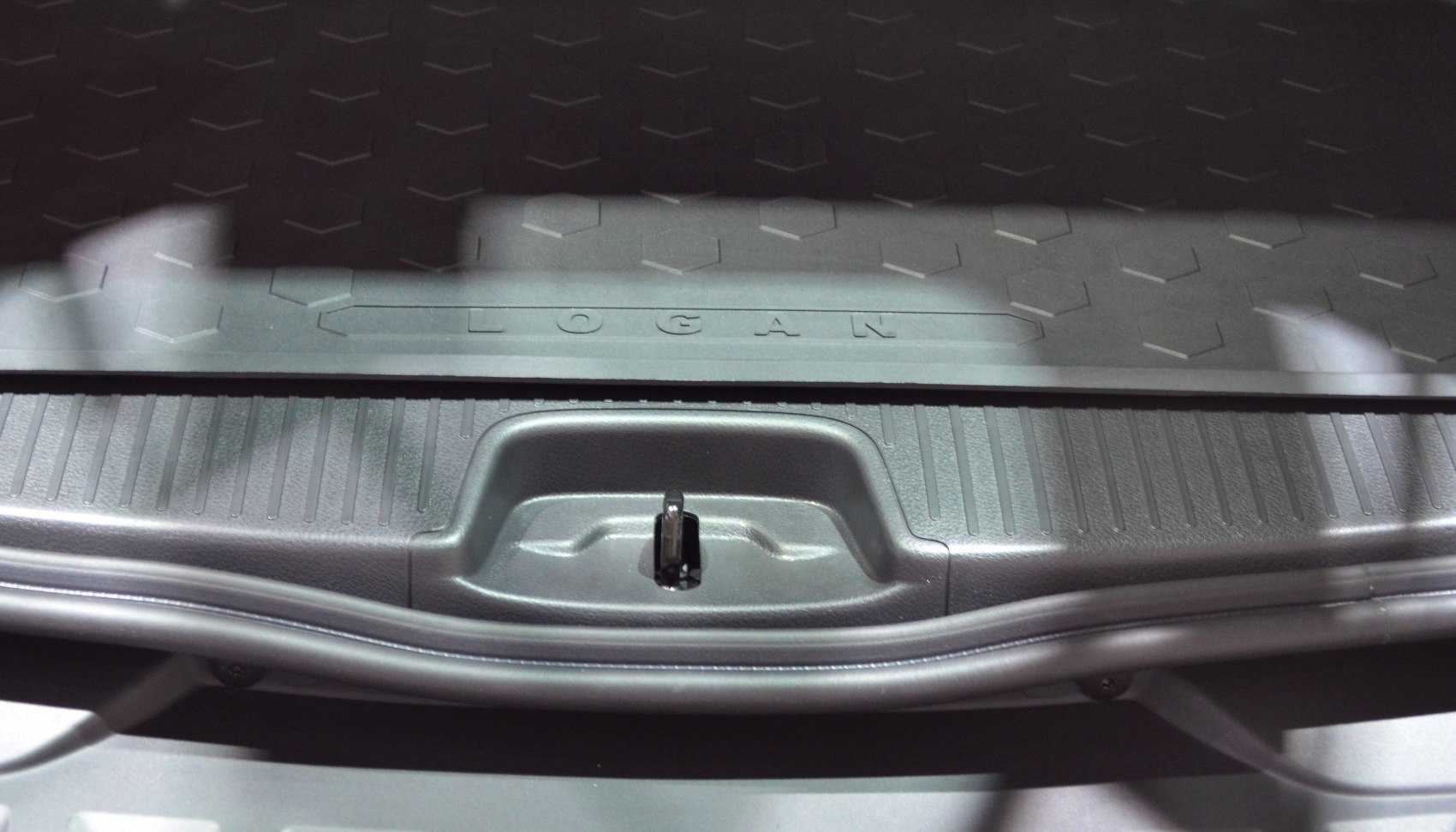 Protective trunk cargo mat with LOGAN inscription and rear latch detail