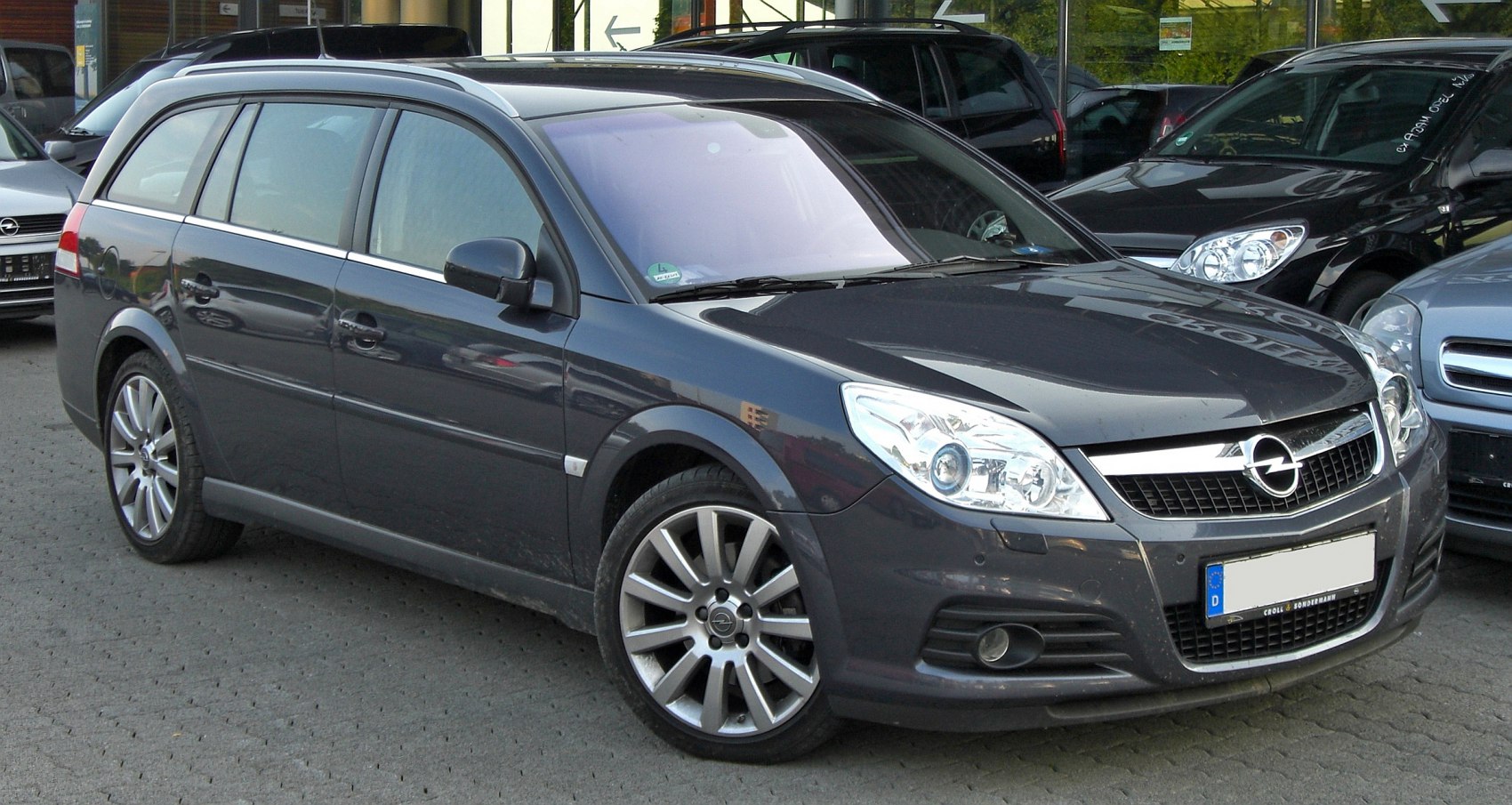 Front side view with distinctive headlights and alloy wheels