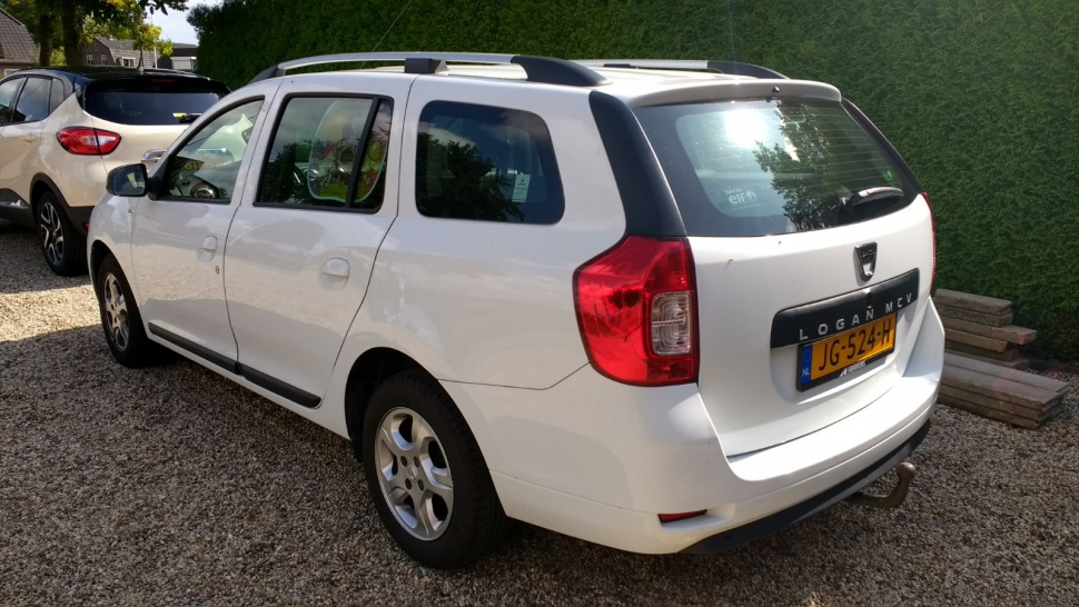 White station wagon with roof rails, rear tail lights, and side view.