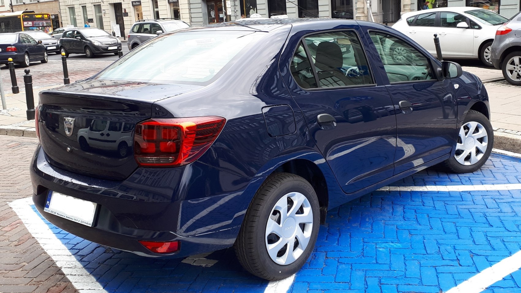 Rear side view of a blue sedan with distinct taillights and compact design
