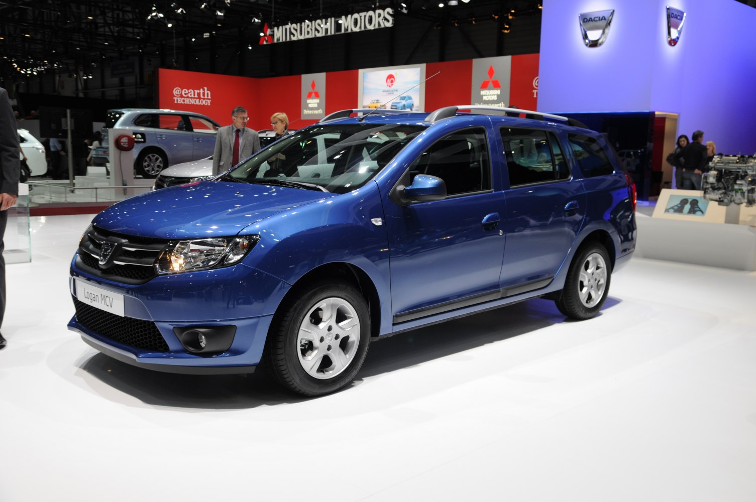 Blue station wagon with prominent front grille, headlights, and roof rails