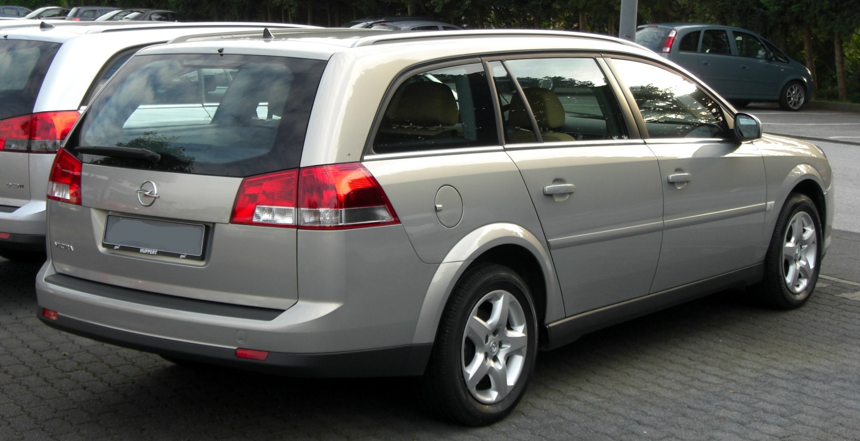 Rear and side view of a silver station wagon with distinctive taillights and alloy wheels