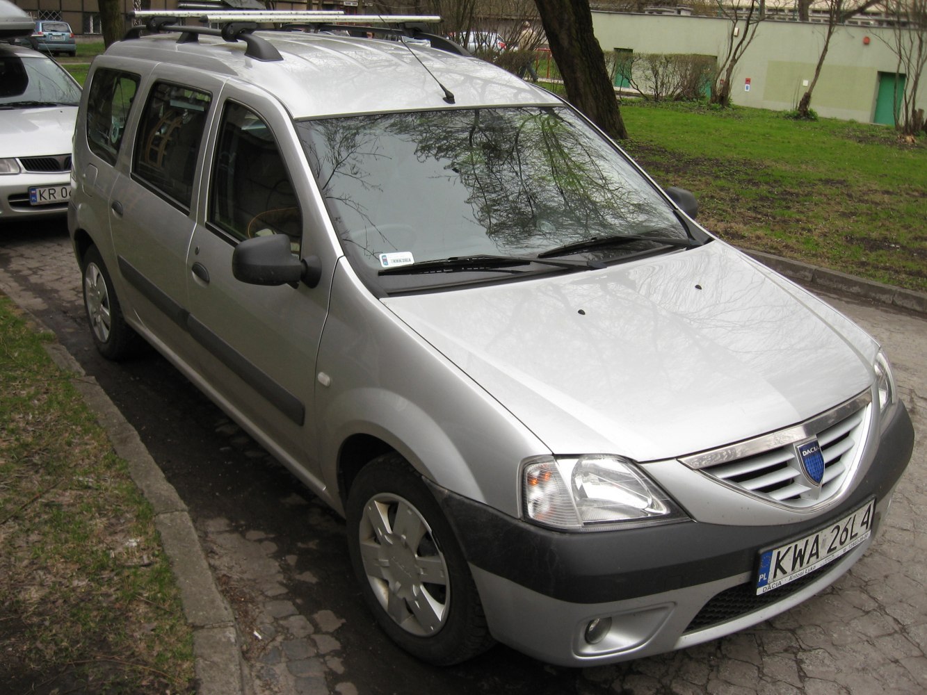 Silver station wagon with roof rails and clear headlamps