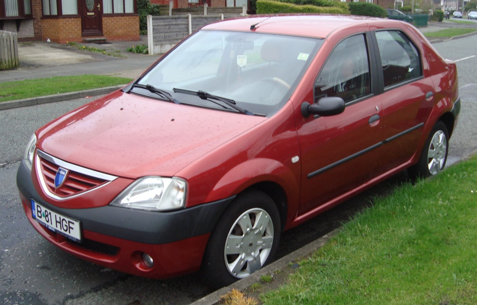 Front side view of a sedan with alloy wheels and prominent front grille