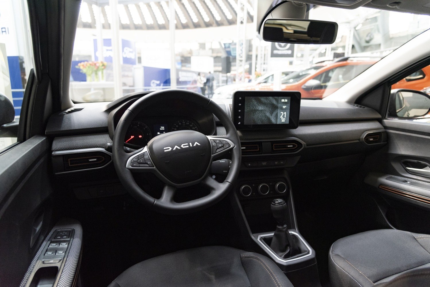 Modern car dashboard with touchscreen, multifunction steering wheel, manual gearshift