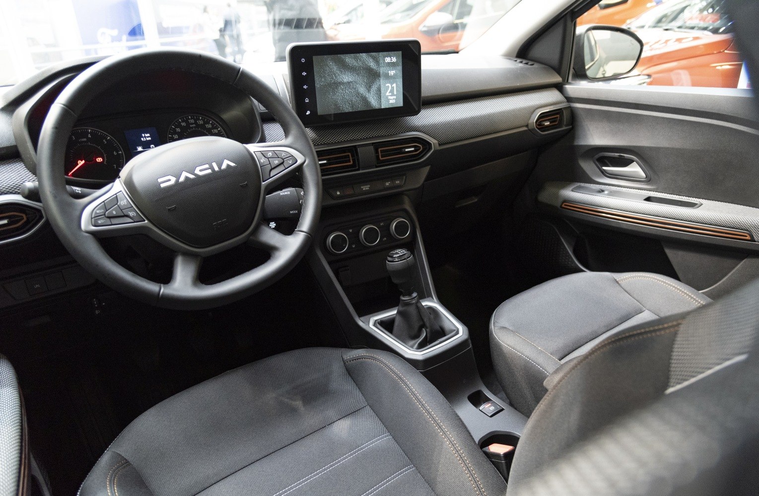 Steering wheel, touchscreen, manual gear shift, dashboard vents