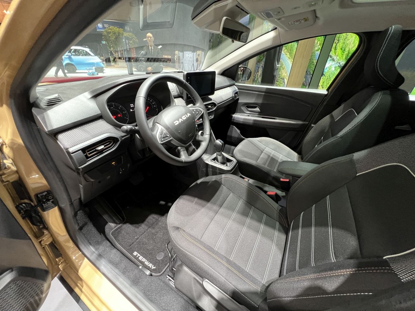 Modern car interior with touchscreen dashboard and fabric seats
