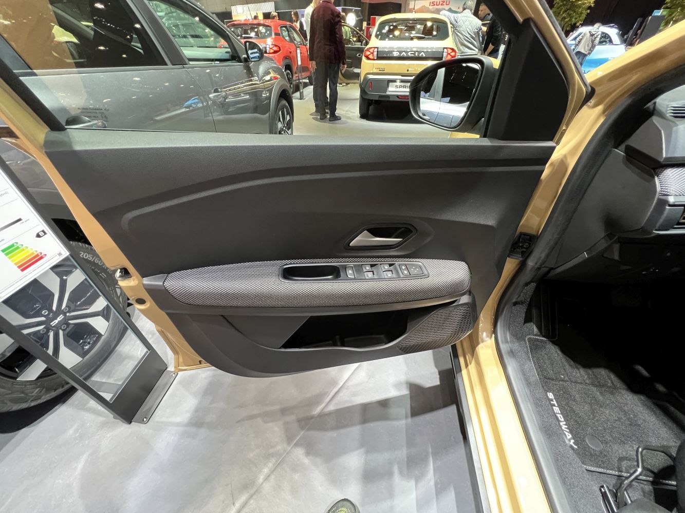 Front interior door panel with power windows and textured armrest