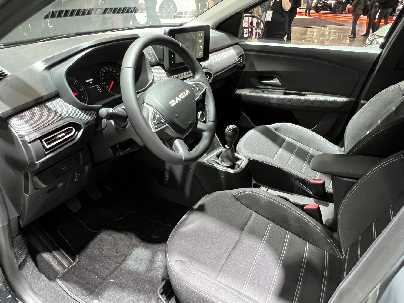 Modern car interior with dashboard, steering wheel, manual transmission