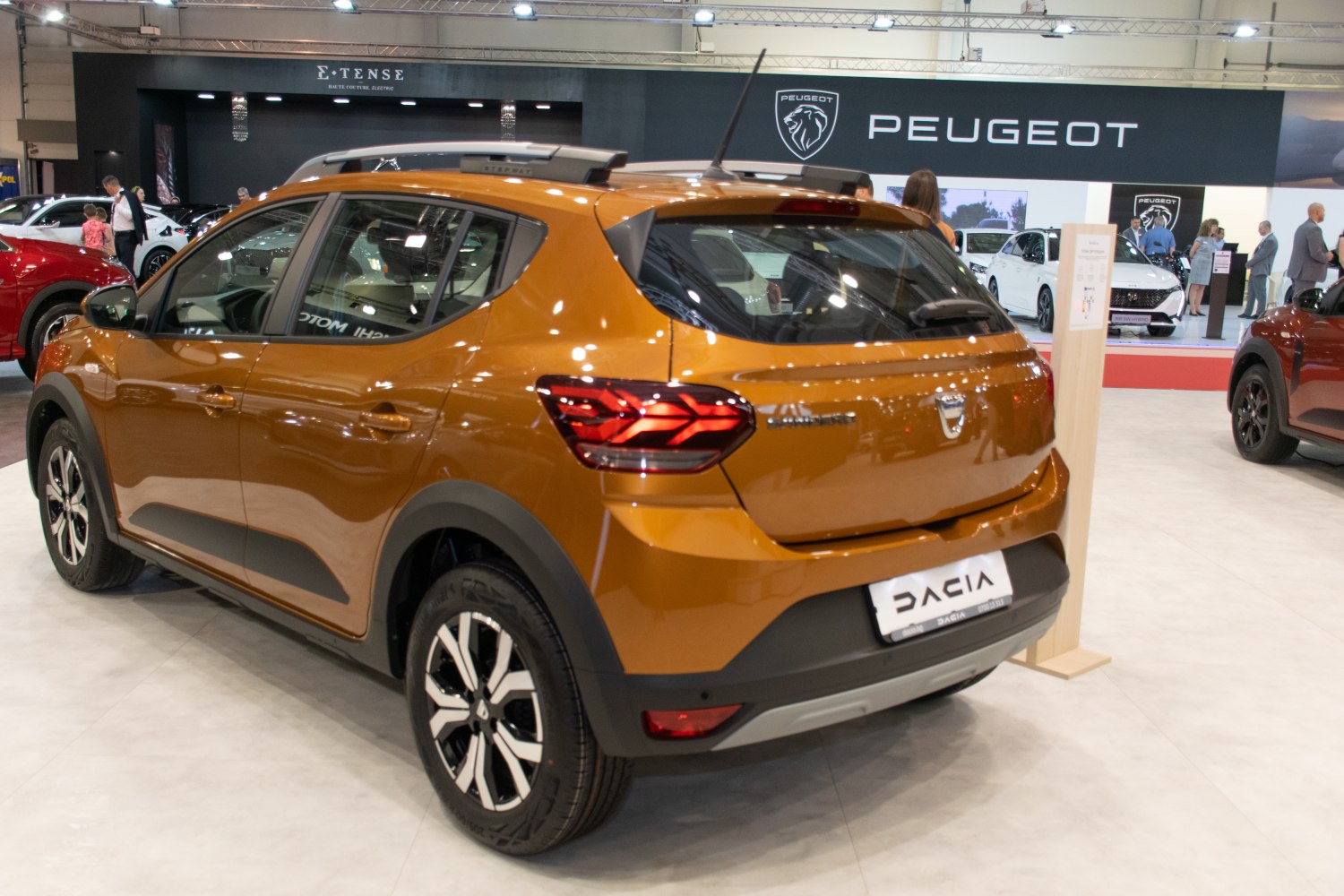 Rear view of crossover with multi-spoke alloy wheels and roof rails