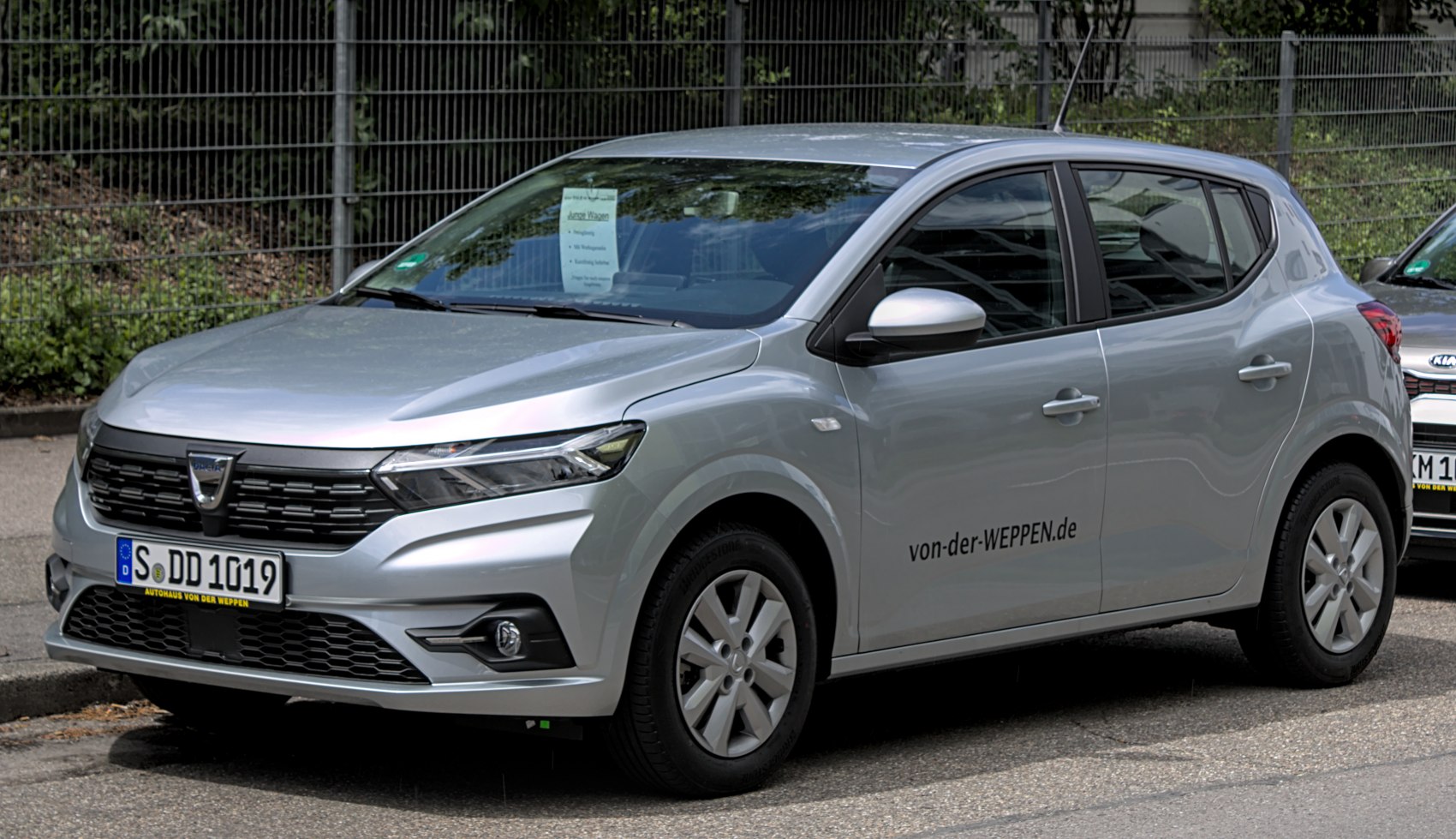 Silver hatchback front-side view with modern grille and headlights