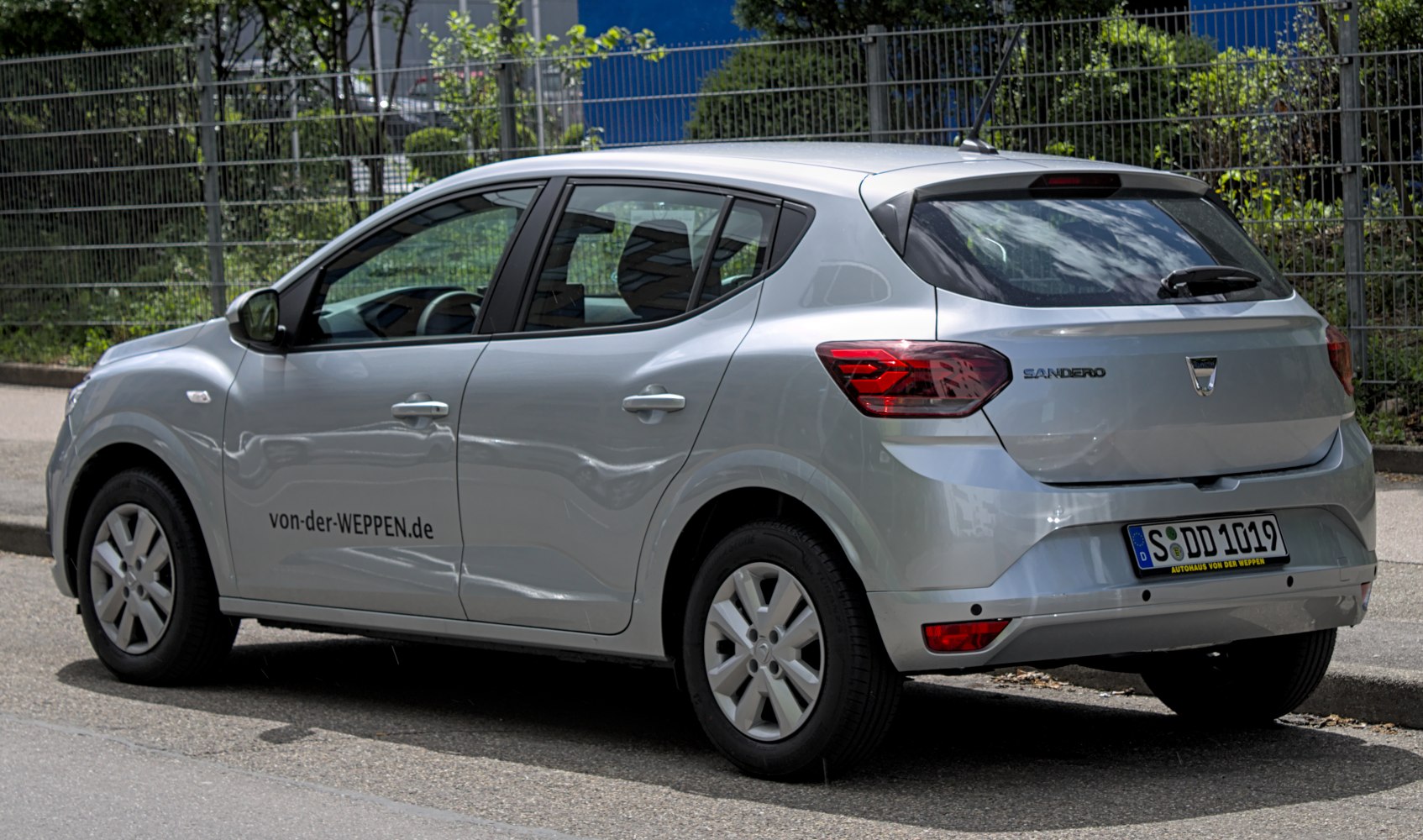 Rear-side view of a silver five-door compact hatchback with distinct taillights.