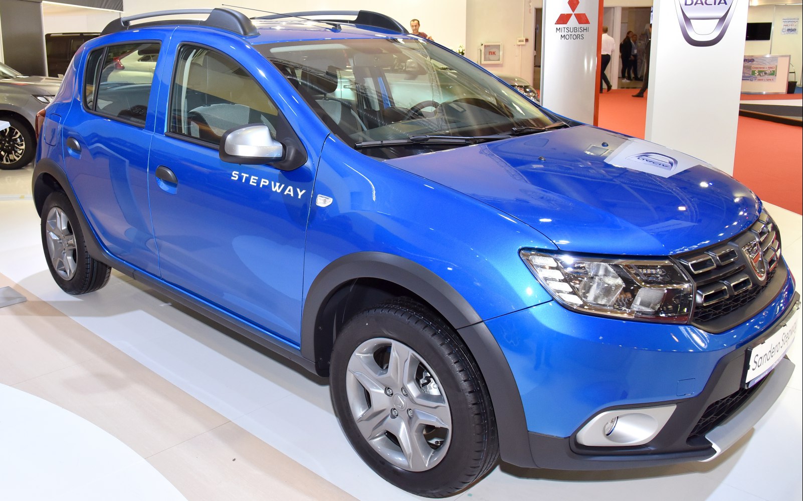 Blue compact SUV with roof rails and modern headlights