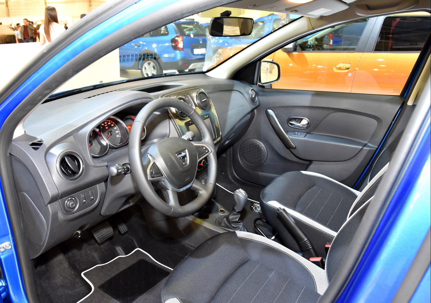 Dashboard, steering wheel, front passenger and driver seats of car interior