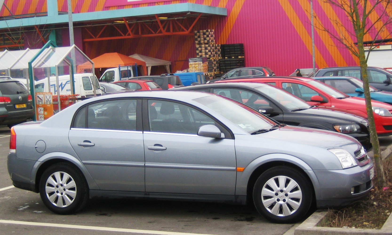 Silver mid-size sedan parked, clear side view with visible alloy wheels