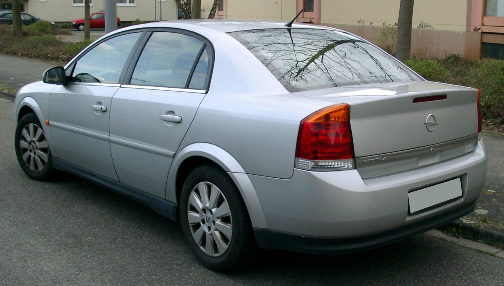 Rear three-quarter view of silver sedan with distinctive taillights and alloy wheels