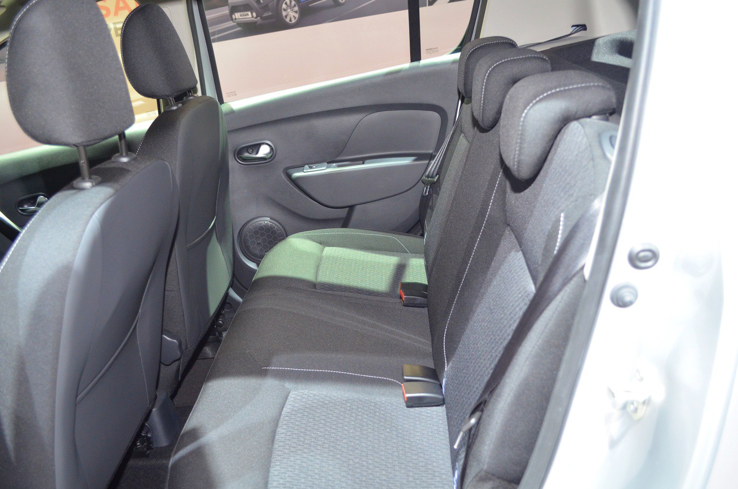Rear passenger seating with fabric upholstery and headrests
