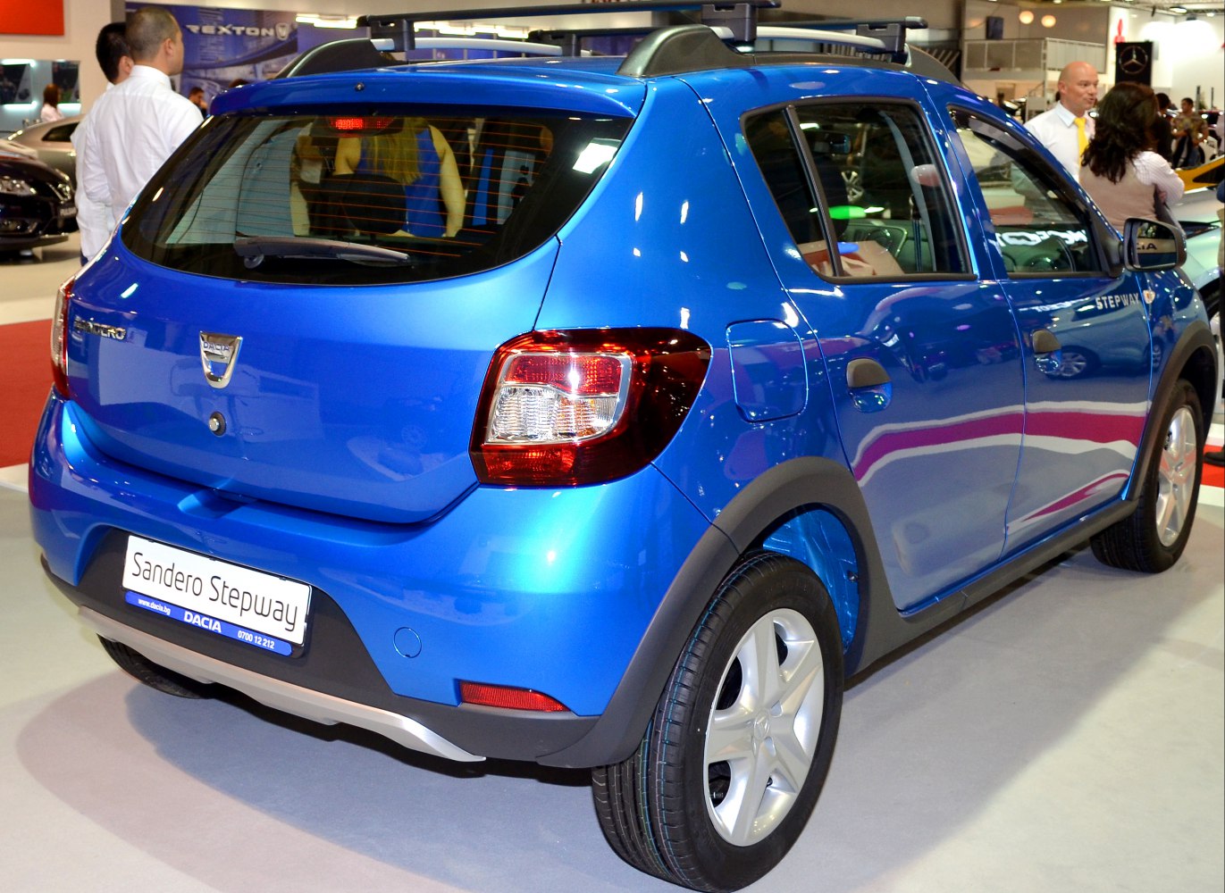 Blue hatchback rear and side view with roof rails and spoiler