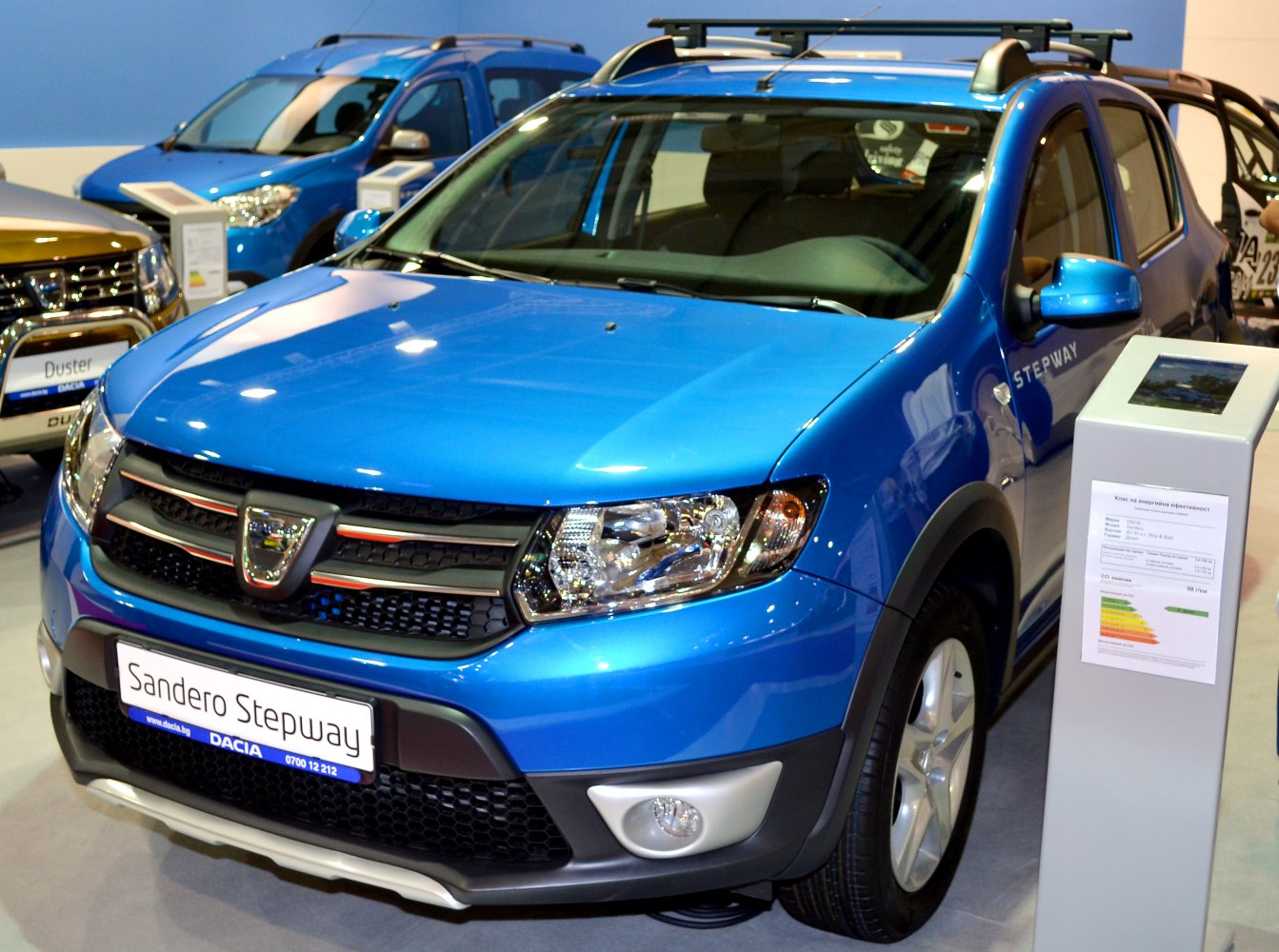 Front grille, headlights, and roof rails of a blue compact crossover