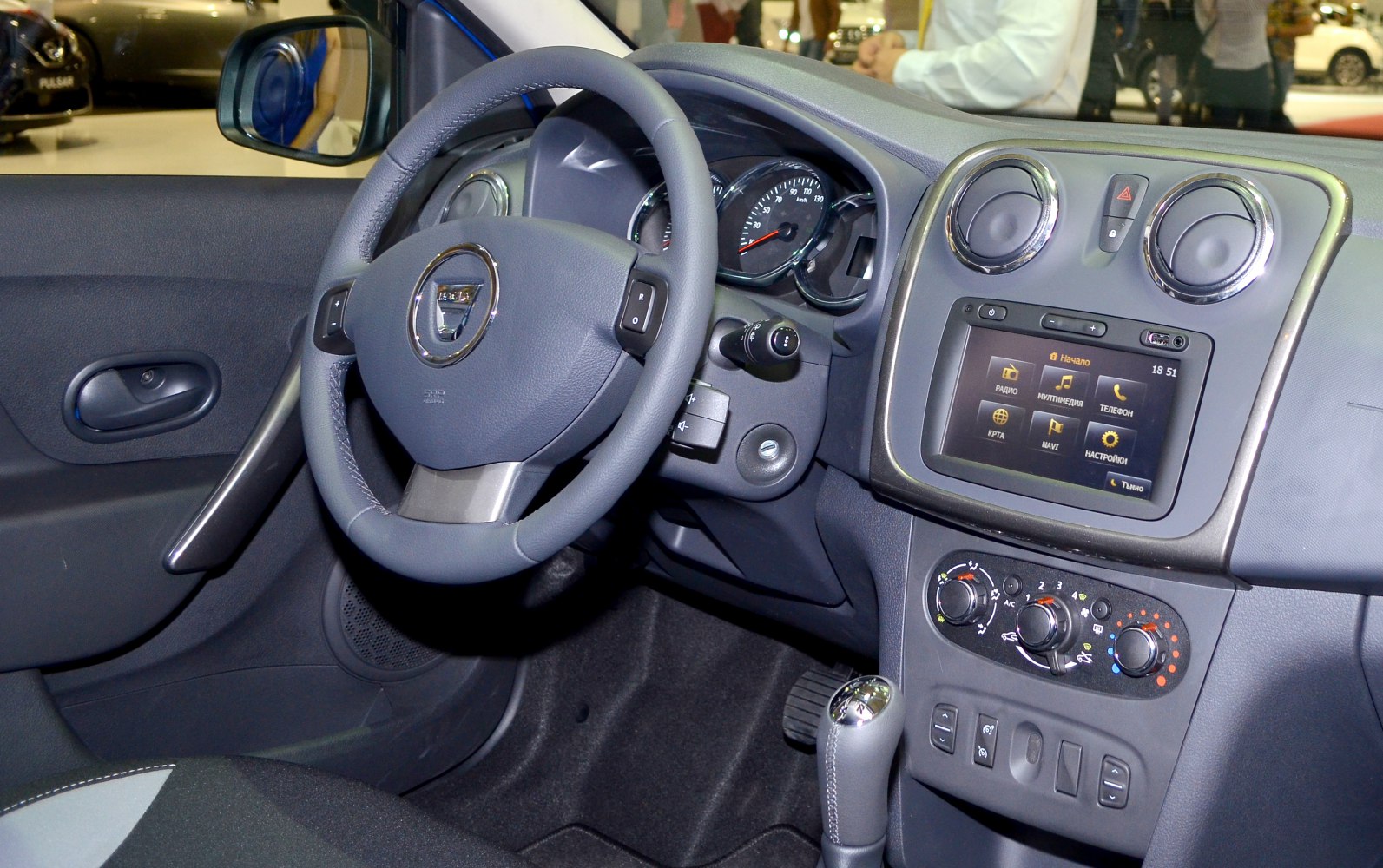 Steering wheel and dashboard with infotainment and climate controls